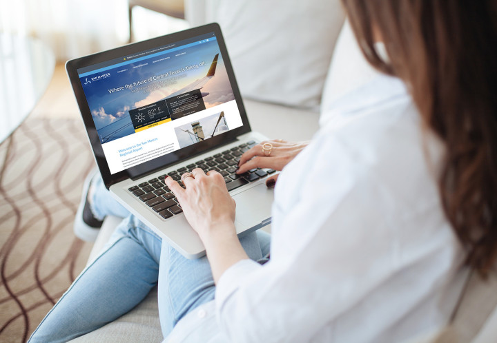 Cropped image of woman using laptop with blank screen